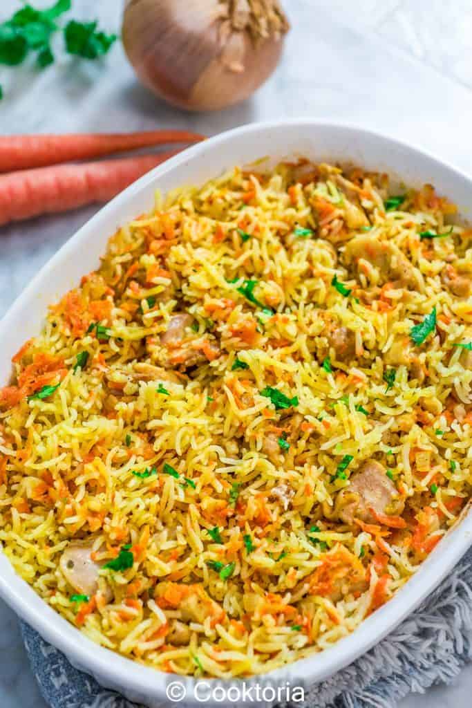Chicken Rice Casserole with veggies on the background